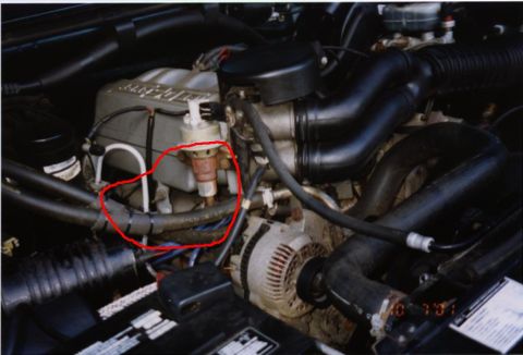 1994 Ford Bronco - Close-up view of an engine bay, focusing on the distributor and associated wiring.