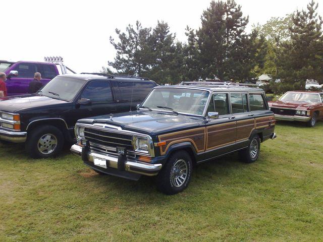 Jeep Grand Wagoneer with woodgrain trim at an outdoor car show