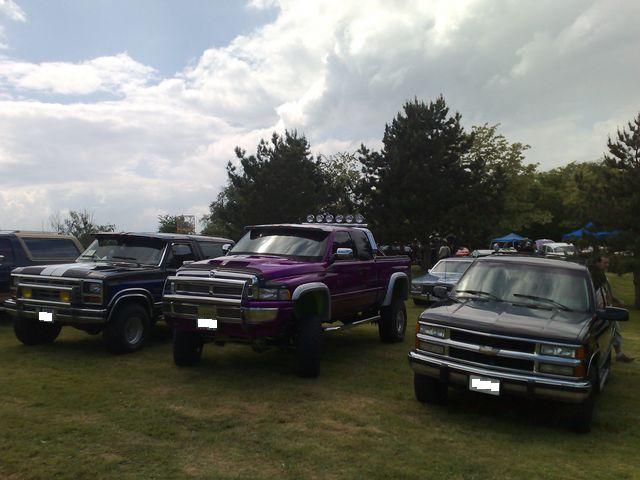 Purple Dodge Ram and other trucks at an outdoor car show