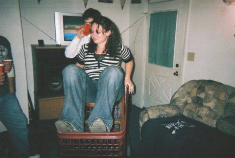 1995 Mercury Grand Marquis - A group of people are socializing indoors, with one woman seated in a unique chair.