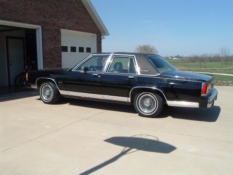 1989 Ford Crown Victoria LTD - This 1989 Ford Crown Victoria LTD is parked in front of a brick garage on a sunny day.