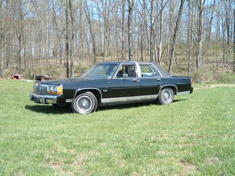 1989 Ford Crown Victoria LTD - This full-size sedan has a vinyl roof and chrome trim details.