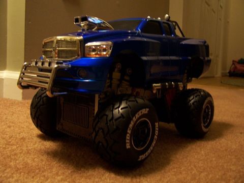 1991 Ford Crown Victoria - This blue monster truck toy has oversized tires and a prominent chrome grille.
