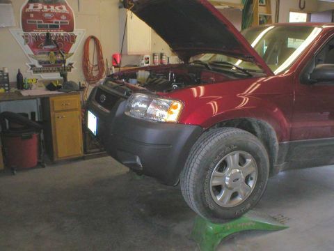 2003 Ford Escape - Ramps make short work of this chore. Locked the 4X4 on, and drove right up. Make sure you set your parking brake, once the vehicle is on th…
