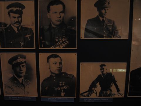 1991 Ford LTD Crown Victoria - museum display of six framed sepia-toned portraits of uniformed WWII military airmen, each with a small caption plaque.