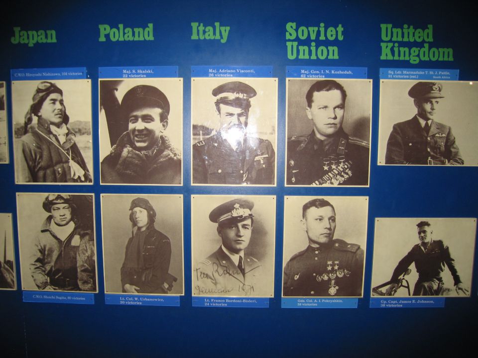Exhibit board of WWII flying aces grouped by nation with portraits