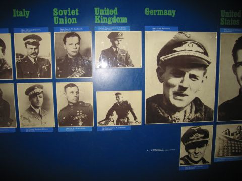 1991 Ford LTD Crown Victoria - blue exhibit board displaying portraits of WWII flying aces grouped under Italy, Soviet Union, United Kingdom, Germany and United States.
