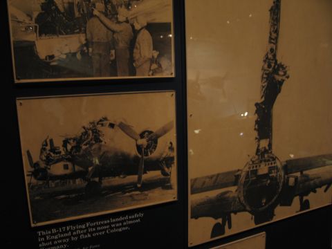 1991 Ford LTD Crown Victoria - Framed sepia photographs of a battle-damaged B-17 Flying Fortress, with a caption noting it landed safely after flak damage over Cologne.