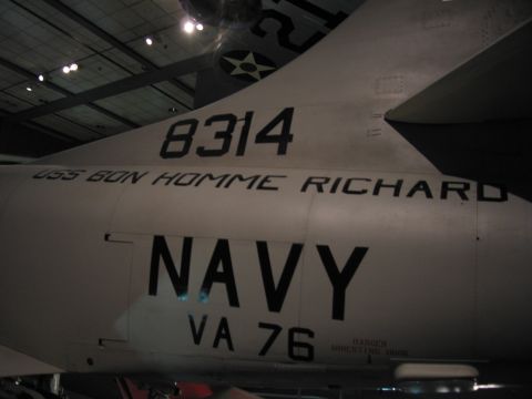 1991 Ford LTD Crown Victoria - gray Navy jet's fuselage bears the markings NAVY, VA 76, 8314 and USS Bon Homme Richard in a museum.