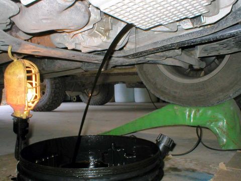 2003 Ford Escape - Here's a hint. Put the drain pan relatively far back to start with. (lesson learned) That oil will shoot out pretty far once the plug is fr…