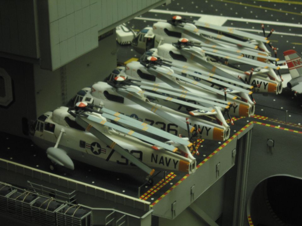Detailed scale model of carrier deck with white Navy helicopters numbered 736 and 739