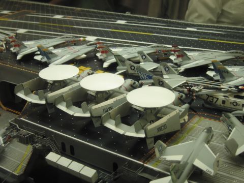 1991 Ford LTD Crown Victoria - model aircraft carrier deck crowded with gray Navy planes and aircraft carrying large white radar domes.