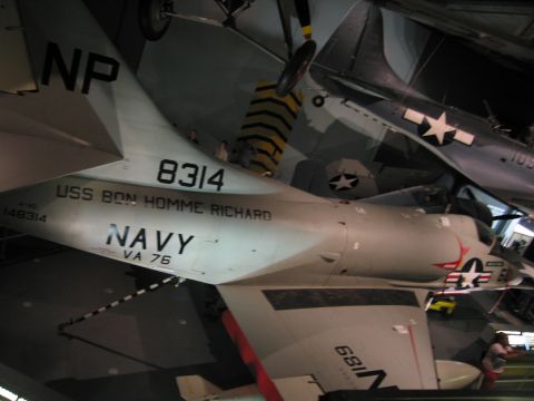 1991 Ford LTD Crown Victoria - rear fuselage of a Navy aircraft lettered 8314, USS BON HOMME RICHARD, NAVY, VA 76 and tail code NP in a museum.