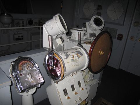 1991 Ford LTD Crown Victoria - ship's gyrocompass binnacle and worn navigation instruments mounted on a vessel's bridge.