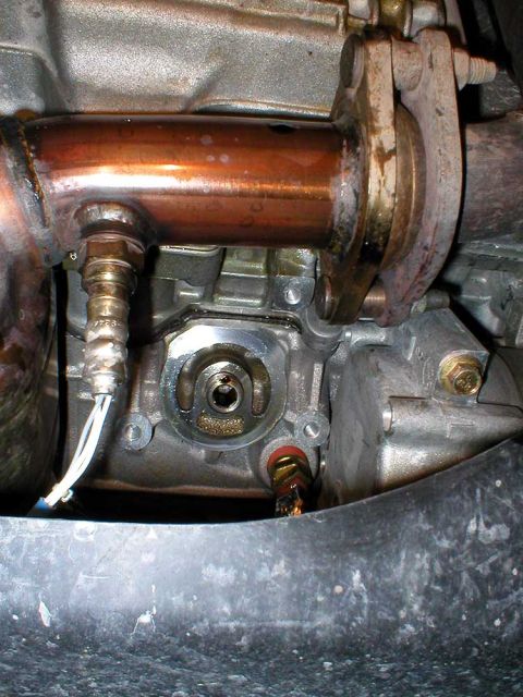 2003 Ford Escape - View of oil filter mounting area. Clean it up well, before installing the new filter. Also, oil will have dripped on the exhaust. Make sure…