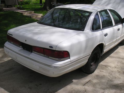 1997 Ford Crown Victoria - Rear view of a white 1997 Ford Crown Victoria, appearing to be a parts car.