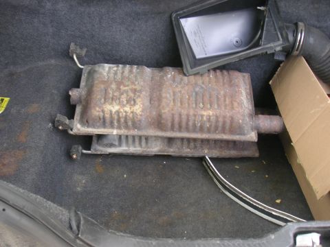 1997 Ford Crown Victoria - Exhaust muffler and air intake box are shown in the trunk of a vehicle.