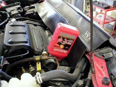 2003 Ford Escape - Ah, the engine's now getting it's fresh Motorcraft 5W-20 synthetic blend motor oil. Fill with the amount of oil specified in your owner's m…