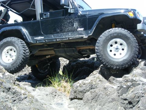 2005 Jeep Wrangler - This Jeep Wrangler is navigating a rocky trail, demonstrating its off-road capabilities.