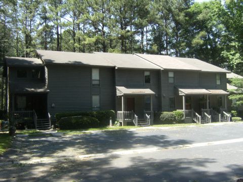 1992 Ford F-150 - A row of townhouses with trees in the background. The image has a watermark at the bottom right.