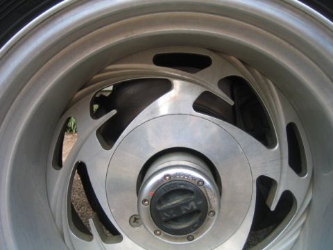 1996 Ford Bronco - A close-up view of a vehicle's wheel hub and rim, showing the "4x4" and "LOCK" indicators on the hub.