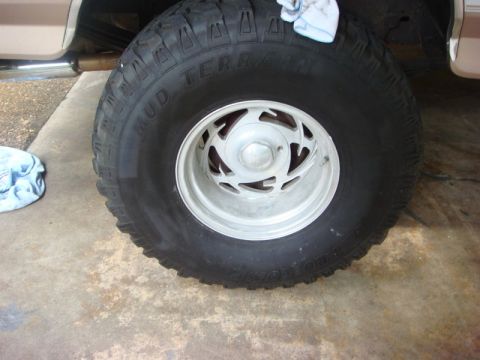 1996 Ford Bronco - A close-up view of a tire and wheel assembly, showing the tread pattern and rim details.