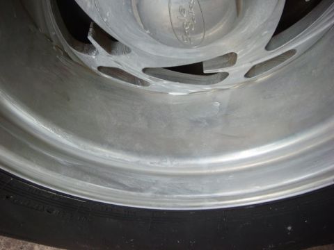 1996 Ford Bronco - Close-up of a polished aluminum wheel an "Eagle Alloys" center cap and tire tread.