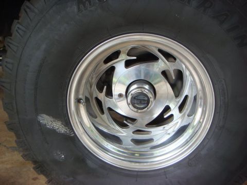 1996 Ford Bronco - Aftermarket wheel and tire detail, with '4x4' visible on the hub.