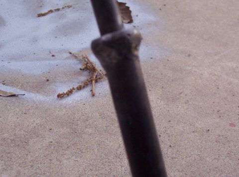 1995 Ford Probe - A close-up shows a metal rod with a weld, likely a vehicle part.