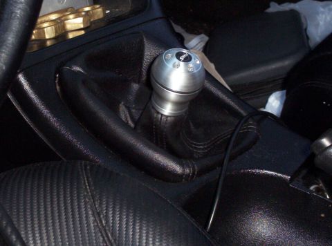 1995 Ford Probe - Interior shot of a car's gear shift knob and part of the driver's seat.