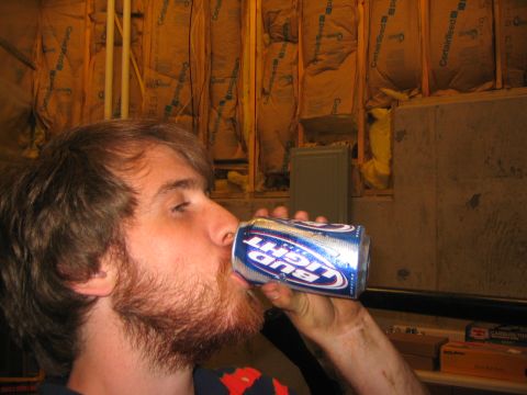1979 Ford Bronco - A man is drinking from a can of Bud Light beer in what appears to be a basement or unfinished room. The walls are covered in insulation and…