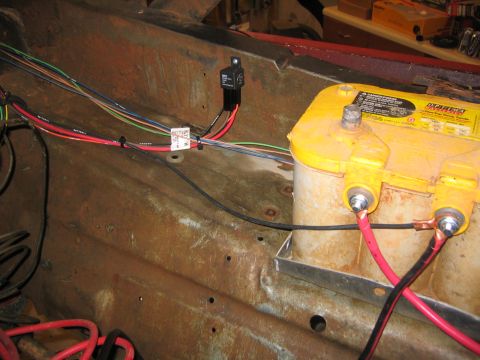 1979 Ford Bronco - A close-up view of a yellow Optima battery and wiring harness installed in a vehicle's engine bay, with a focus on electrical components an…