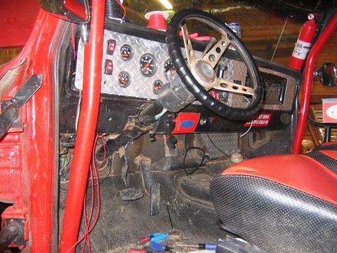 1979 Ford Bronco - The complex wiring harness and dashboard components of a vehicle are visible in this interior shot.