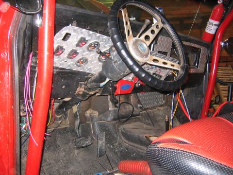 1979 Ford Bronco - Custom interior features extensive wiring, multiple gauges, and a roll cage, suggesting significant modifications.