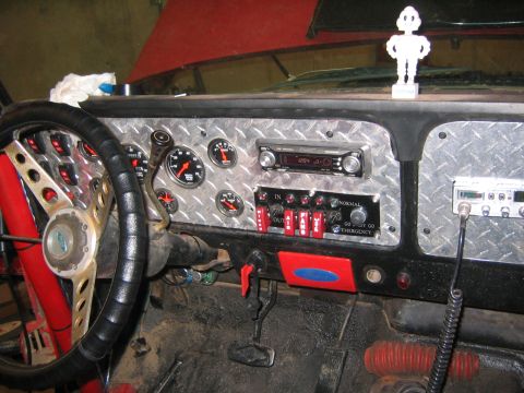 1979 Ford Bronco - The interior of a modified vehicle, likely a 1979 Ford Bronco, features a custom diamond plate dashboard with multiple gauges, a stereo, an…