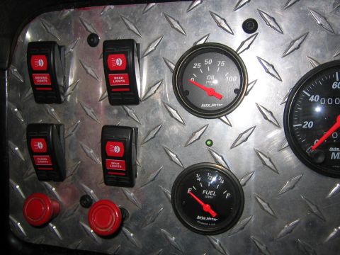 1979 Ford Bronco - A close-up view of a custom dashboard with four toggle switches labeled 'DRIVING LIGHTS', 'REAR LIGHTS', 'FLOOD LIGHTS', and 'SPOT LIGHTS'.…