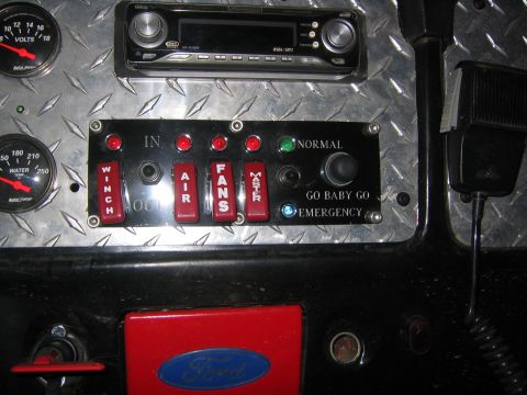 1979 Ford Bronco - The interior of a vehicle shows a dashboard with gauges, a car stereo, and a panel of switches labeled "WINCH", "AIR", "FANS", and "MASTER"…