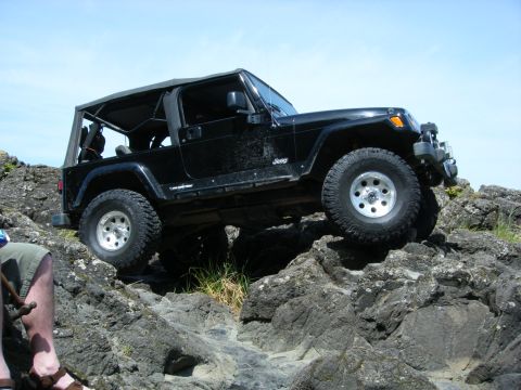 1994 Ford Explorer - Off-road Jeep Wrangler navigating a rocky landscape.