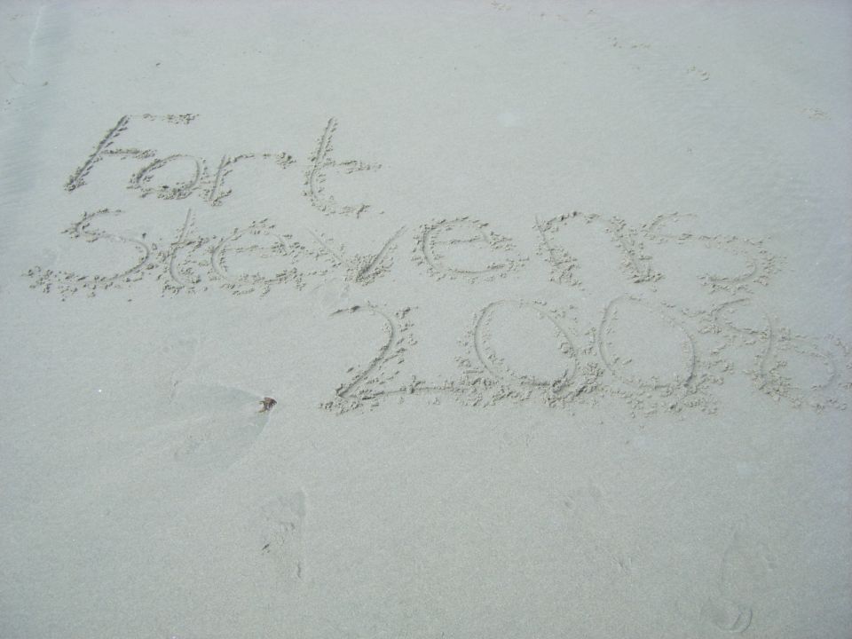 Writing in sand reads 'Fort Stevens 2006'
