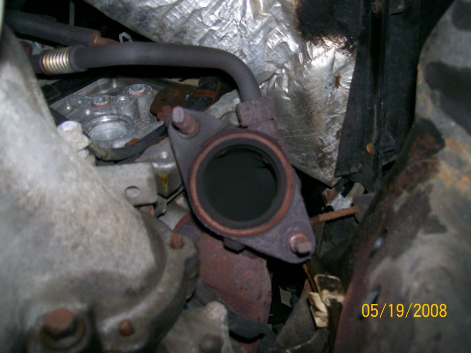 Exhaust pipe flange connection with rust and carbon buildup. Date stamp 05/19/2008