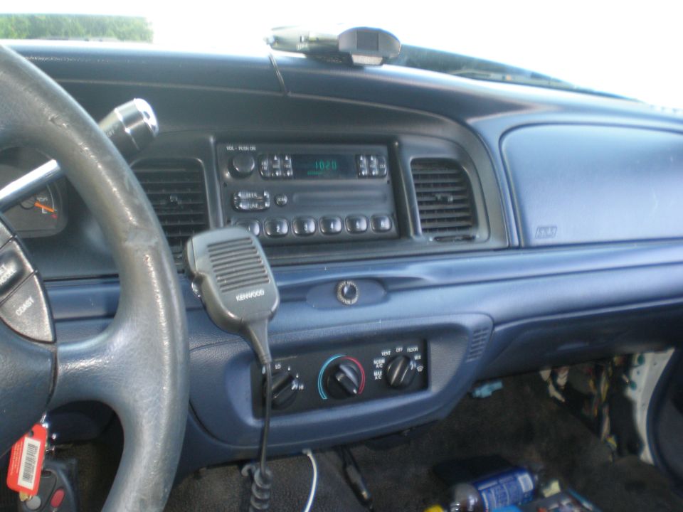 Interior of a 1996 Ford Crown Victoria with a Kenwood microphone and aftermarket radio