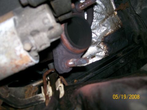 1995 Mercury Grand Marquis - Underside view of a vehicle's exhaust system components, including a catalytic converter.
