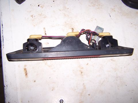 1995 Ford C-350 (Centurion Conversions) - This is a close-up view of a vehicle's brake light assembly, showing its internal wiring and mounting points.