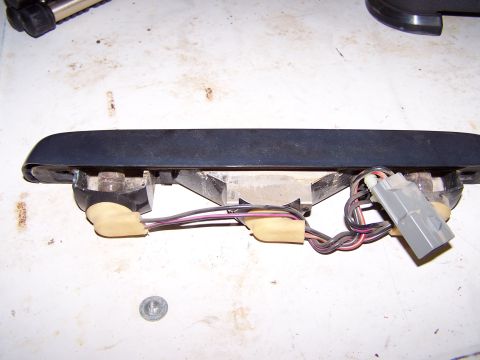 1995 Ford C-350 (Centurion Conversions) - Close-up of a detached vehicle light fixture, showing its internal wiring and connector.