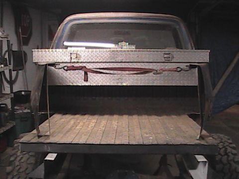 1980 Dodge Magnum - Rear view of a pickup truck a diamond plate toolbox and a wooden bed.