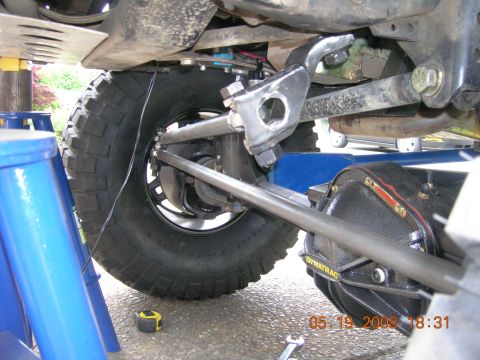 1996 Ford Bronco - Close-up view of a vehicle's undercarriage, focusing on the suspension and differential.