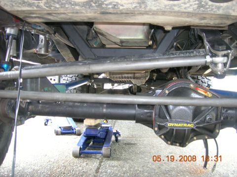 1996 Ford Bronco - Close-up view of the undercarriage, highlighting the Dynatrac differential cover and modified suspension system.