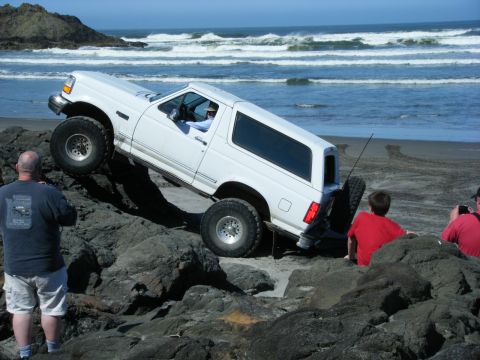 1994 Ford Explorer - 1994 Ford Explorer navigating a rocky beach near the ocean.