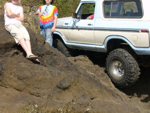 1978 Ford Bronco - 1978 Ford Bronco navigating a rocky coastal terrain.