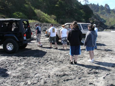1978 Ford Bronco - Several people gather on a beach next to a Jeep Wrangler and a Toyota 4Runner.